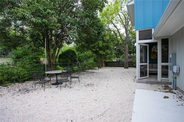 6613 Woodrow Ave, Austin, TX 78757 - view of yard with outdoor dining space, a patio area, and view of wooded area