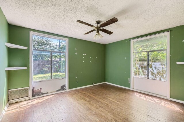 1611 Suffolk Dr, Austin, TX 78723 - spare room with wood-type flooring, ceiling fan, and a textured ceiling