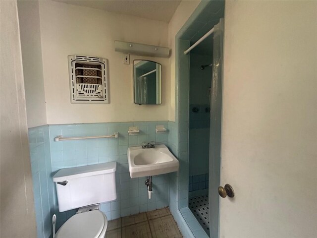 1611 Suffolk Dr, Austin, TX 78723 - bathroom with a shower stall, tile walls, tile patterned flooring, and wainscoting