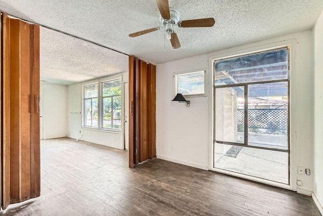 1611 Suffolk Dr, Austin, TX 78723 - spare room with a textured ceiling, wood finished floors, healthy amount of natural light, and a ceiling fan