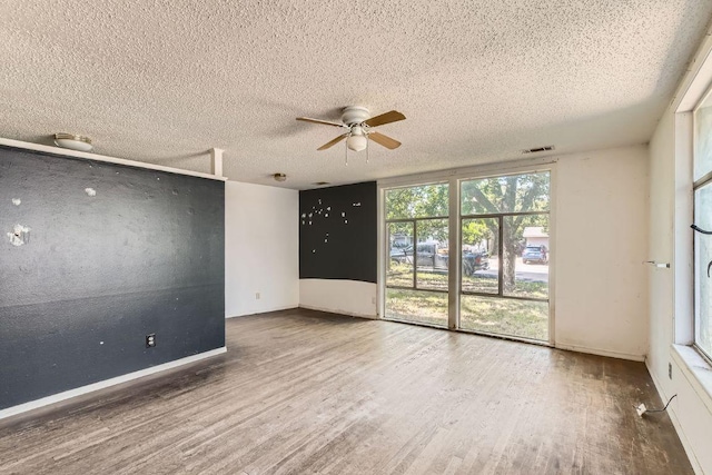 1611 Suffolk Dr, Austin, TX 78723 - unfurnished room featuring wood finished floors, ceiling fan, and a textured ceiling