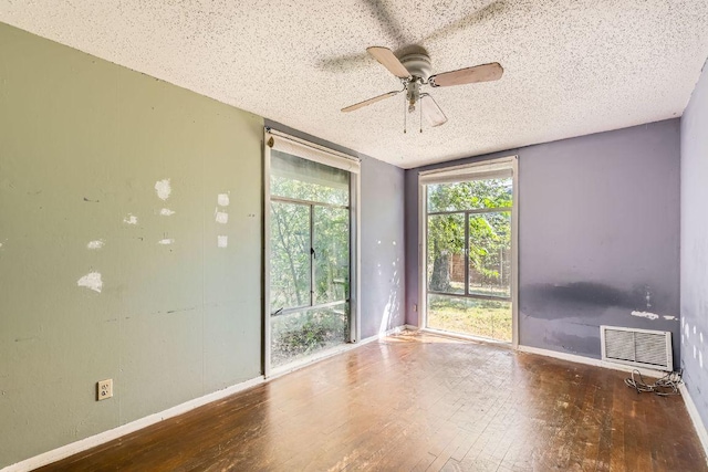 1611 Suffolk Dr, Austin, TX 78723 - unfurnished room with wood-type flooring, a textured ceiling, and a ceiling fan