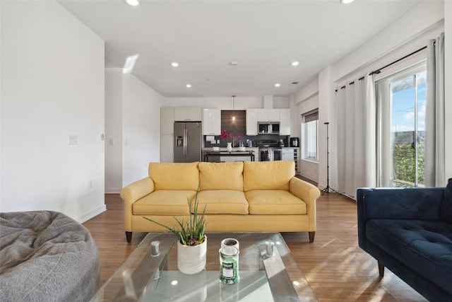 4361 S Congress Ave Unit 209, Austin, TX 78745 - living room featuring light wood finished floors and recessed lighting