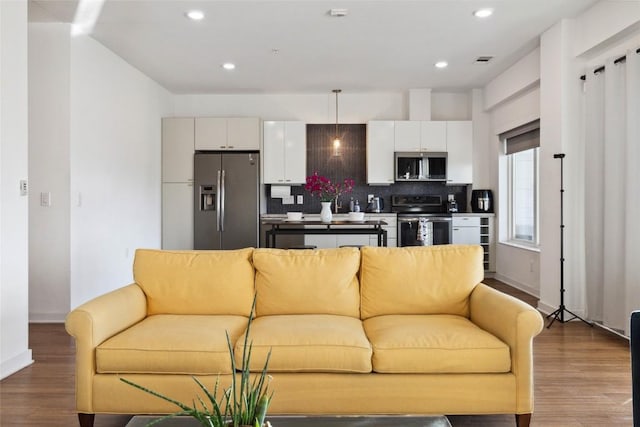 4361 S Congress Ave Unit 209, Austin, TX 78745 - living area featuring wood finished floors and recessed lighting