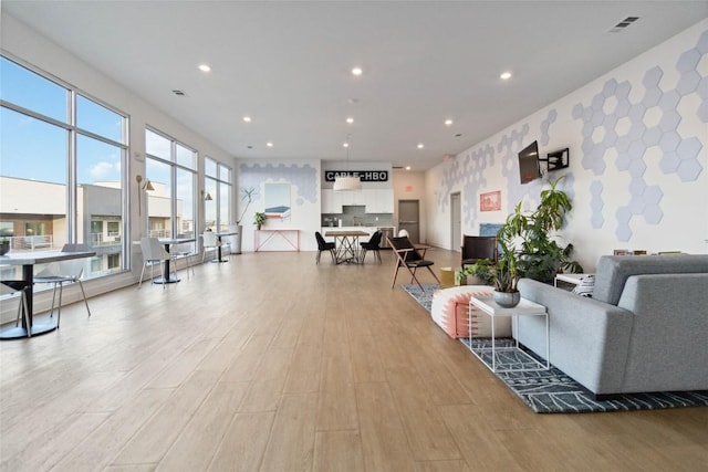 4361 S Congress Ave Unit 209, Austin, TX 78745 - living area with light wood finished floors and recessed lighting