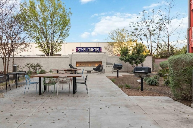 4361 S Congress Ave Unit 209, Austin, TX 78745 - view of patio with outdoor dining area and a grill