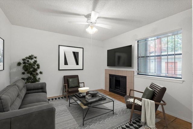 4405 Ave A Unit 5, Austin, TX 78751 - tiled living room with a tile fireplace, a textured ceiling, and a ceiling fan