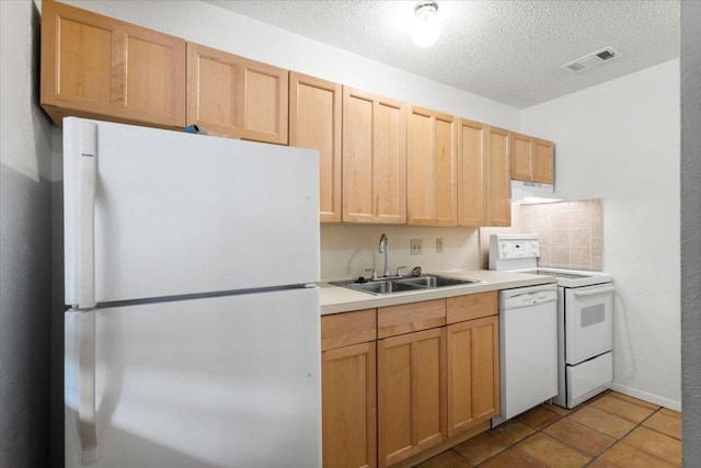 4405 Ave A Unit 5, Austin, TX 78751 - kitchen featuring white appliances, light countertops, under cabinet range hood, light brown cabinets, and a textured ceiling