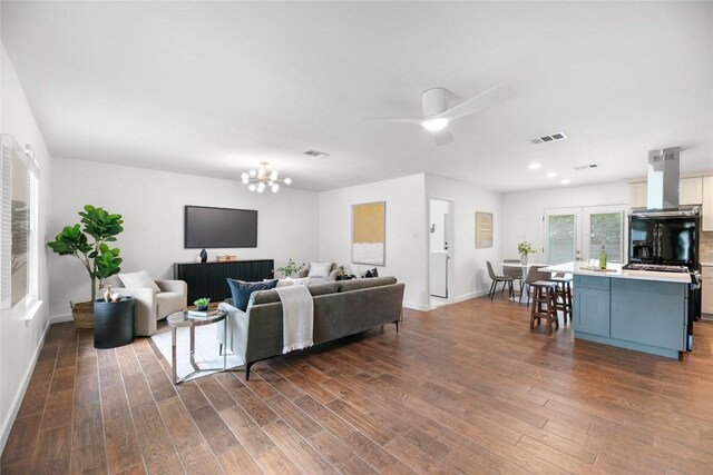 2518 Carlow Dr, Austin, TX 78745 - living area featuring dark wood-style floors, a chandelier, and a ceiling fan