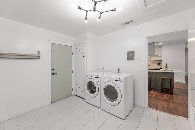 2518 Carlow Dr, Austin, TX 78745 - laundry area featuring washer and dryer, light tile patterned floors, and electric panel