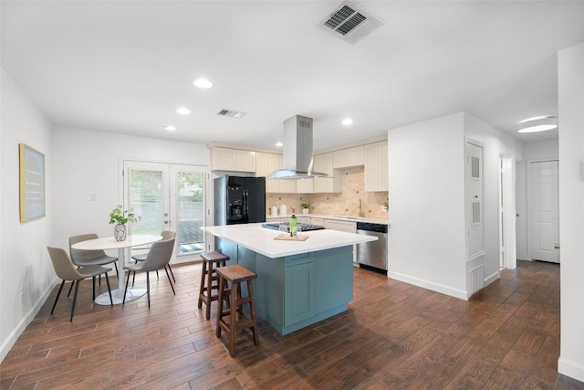 2518 Carlow Dr, Austin, TX 78745 - kitchen with island range hood, appliances with stainless steel finishes, a kitchen island, dark wood-style flooring, and light countertops