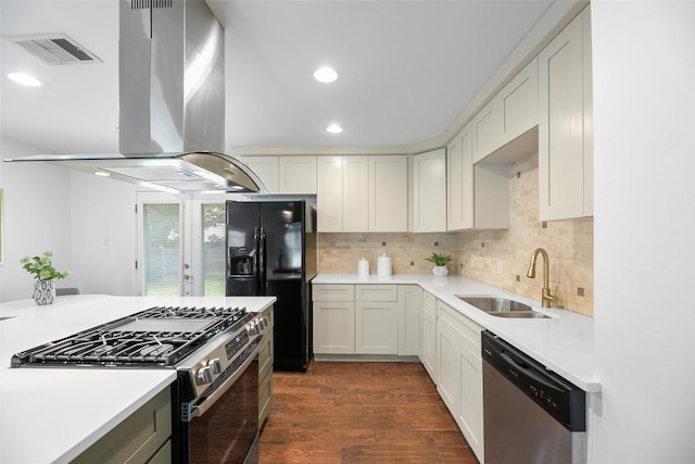 2518 Carlow Dr, Austin, TX 78745 - kitchen with appliances with stainless steel finishes, island range hood, light countertops, dark wood-style floors, and recessed lighting