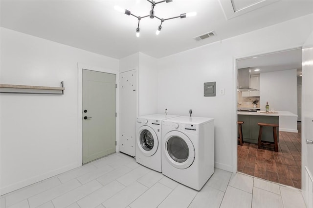 2518 Carlow Dr, Austin, TX 78745 - laundry area with separate washer and dryer, electric panel, and light tile patterned flooring