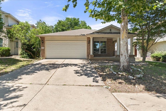 2306 Billy Fiske Ln, Austin, TX 78748 - view of front of house featuring an attached garage, brick siding, and concrete driveway