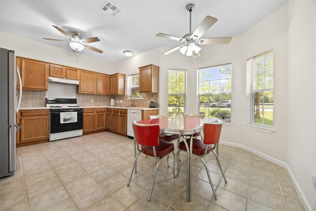 803 N Myrtle St, Georgetown, TX 78626 - kitchen with white appliances, under cabinet range hood, a ceiling fan, and decorative backsplash