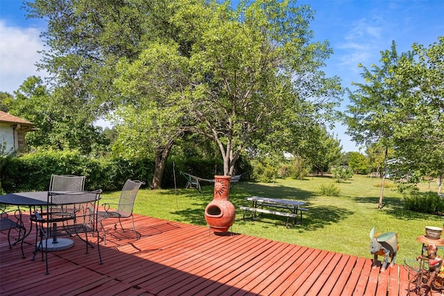 803 N Myrtle St, Georgetown, TX 78626 - wooden deck with outdoor dining space, a yard, and view of wooded area