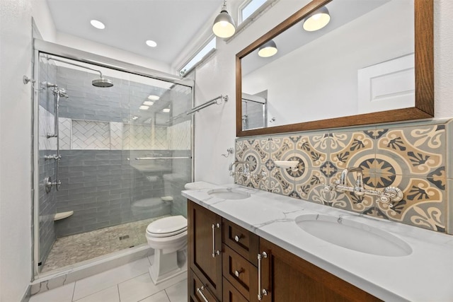 803 N Myrtle St, Georgetown, TX 78626 - bathroom with double vanity, a shower stall, tile patterned floors, recessed lighting, and tasteful backsplash