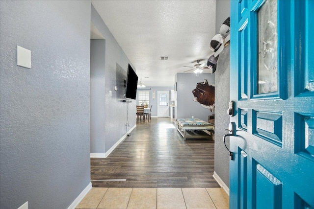 1220 Redstone Dr, Temple, TX 76502 - foyer with a textured wall, ceiling fan, a textured ceiling, and tile patterned floors
