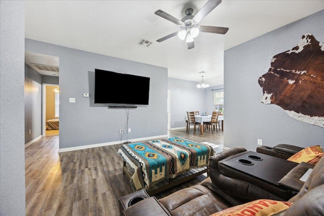 1220 Redstone Dr, Temple, TX 76502 - living room featuring wood finished floors, a ceiling fan, and a chandelier
