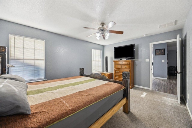 1220 Redstone Dr, Temple, TX 76502 - bedroom featuring a textured ceiling, carpet flooring, and a ceiling fan