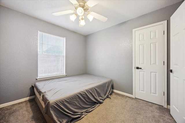 1220 Redstone Dr, Temple, TX 76502 - bedroom featuring carpet floors, a ceiling fan, and a textured wall