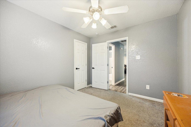 1220 Redstone Dr, Temple, TX 76502 - bedroom with light colored carpet, a textured wall, and ceiling fan