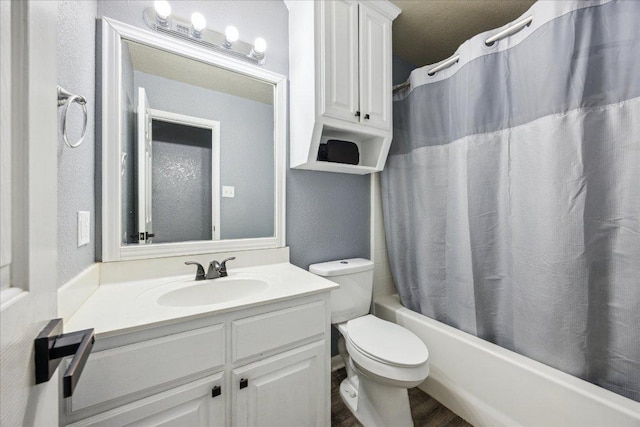 1220 Redstone Dr, Temple, TX 76502 - full bath featuring vanity, shower / bathtub combination with curtain, a textured wall, and wood finished floors