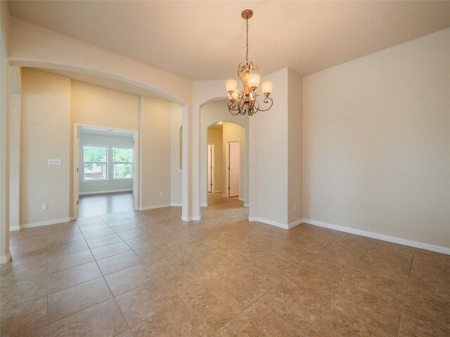 457 Monahans Dr, Georgetown, TX 78628 - unfurnished room featuring arched walkways, a chandelier, and light tile patterned floors
