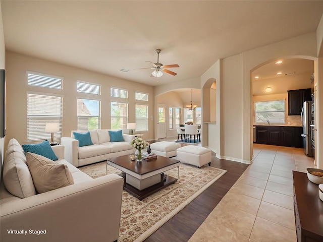 457 Monahans Dr, Georgetown, TX 78628 - living room with arched walkways, ceiling fan, a chandelier, light wood-type flooring, and recessed lighting
