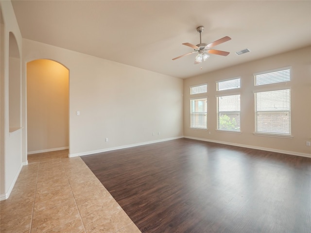 457 Monahans Dr, Georgetown, TX 78628 - spare room with arched walkways, ceiling fan, and wood finished floors