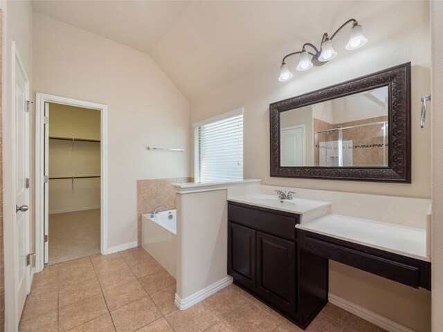 457 Monahans Dr, Georgetown, TX 78628 - full bath featuring tile patterned floors, a garden tub, vanity, tiled shower, and lofted ceiling