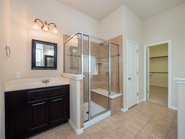 457 Monahans Dr, Georgetown, TX 78628 - bathroom with a stall shower, vanity, a spacious closet, and tile patterned floors