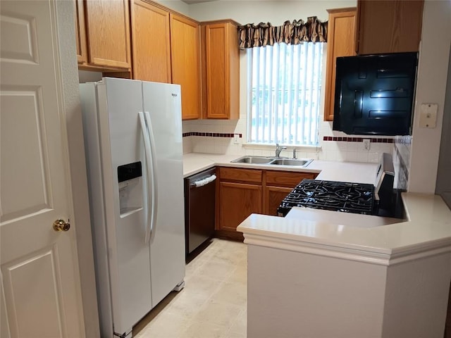 12401 Los Indios Trl Unit 9, Austin, TX 78729 - kitchen featuring black appliances, a peninsula, backsplash, and light countertops