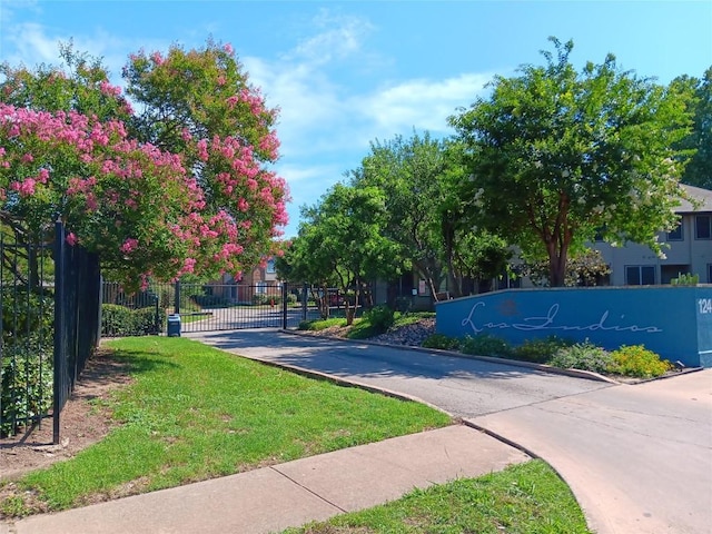 12401 Los Indios Trl Unit 9, Austin, TX 78729 - view of concrete road with curbs and a gated entry