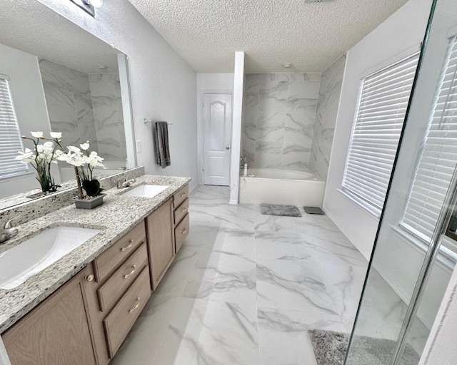 15304 Iola Cv, Austin, TX 78717 - full bathroom with marble finish flooring, a garden tub, double vanity, a textured ceiling, and plenty of natural light