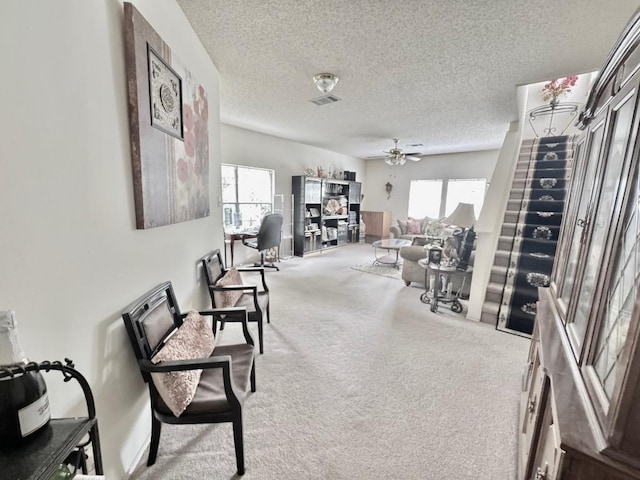 15304 Iola Cv, Austin, TX 78717 - living area featuring healthy amount of natural light, carpet, ceiling fan, and a textured ceiling