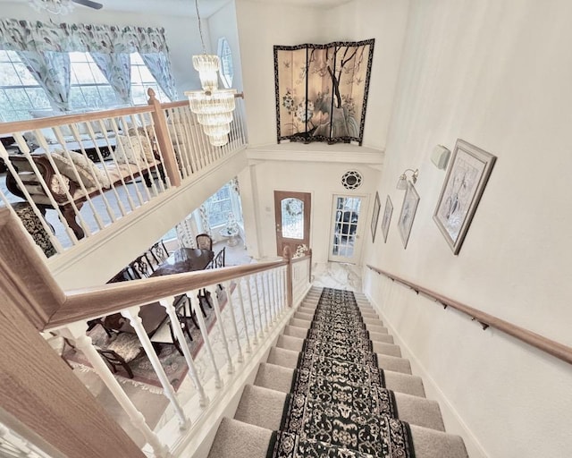 15304 Iola Cv, Austin, TX 78717 - staircase featuring a towering ceiling, a chandelier, and plenty of natural light