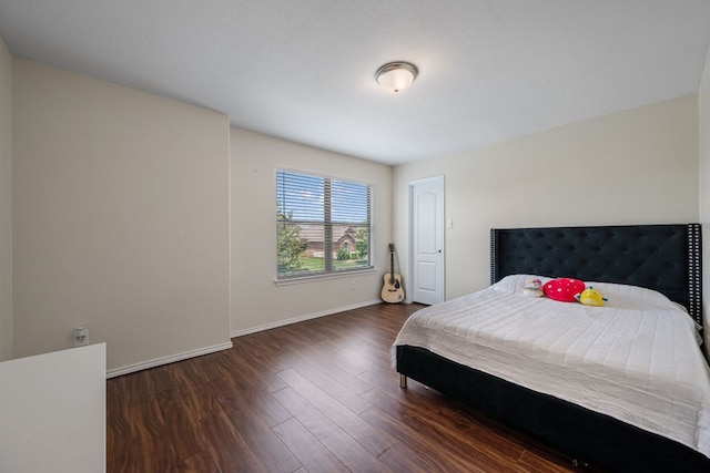 808 Lonesome Lilly Way, Pflugerville, TX 78660 - bedroom with baseboards and wood finished floors