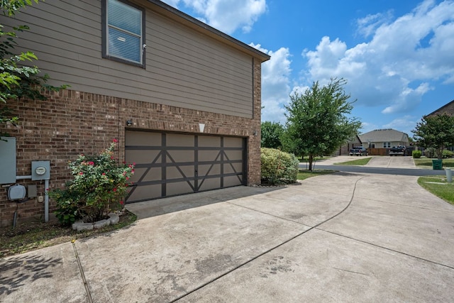 808 Lonesome Lilly Way, Pflugerville, TX 78660 - view of side of property with brick siding, an attached garage, and driveway
