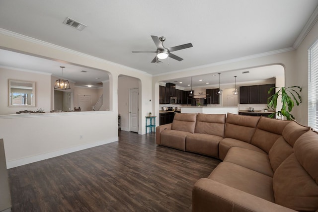 808 Lonesome Lilly Way, Pflugerville, TX 78660 - living area with dark wood-style flooring, ceiling fan, healthy amount of natural light, crown molding, and arched walkways