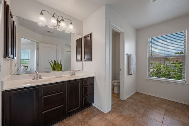 808 Lonesome Lilly Way, Pflugerville, TX 78660 - bathroom with double vanity and toilet