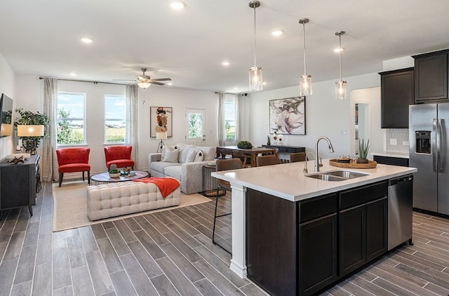 1700 Lorant Ln, Pflugerville, TX 78660 - kitchen featuring appliances with stainless steel finishes, open floor plan, dark wood-type flooring, healthy amount of natural light, and recessed lighting