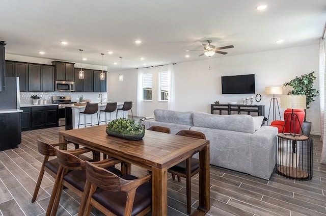 1700 Lorant Ln, Pflugerville, TX 78660 - dining area featuring wood tiled floors, ceiling fan, and recessed lighting