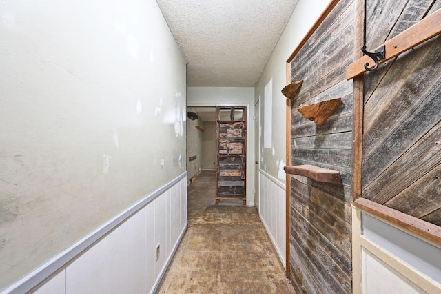 10410 Margra Ln, Austin, TX 78748 - hallway with a textured ceiling and a wainscoted wall