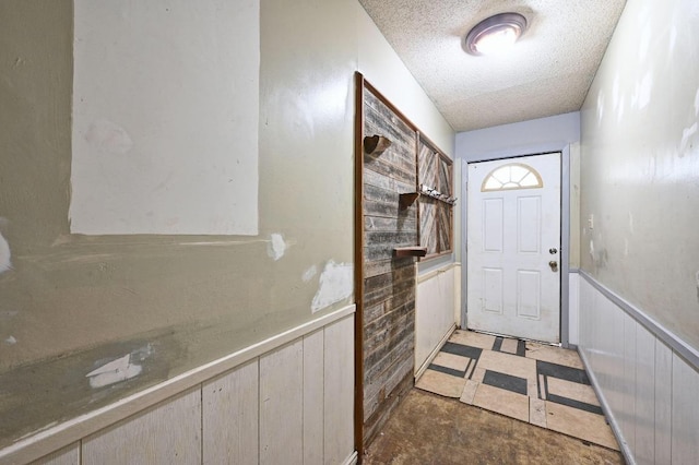10410 Margra Ln, Austin, TX 78748 - doorway to outside with a textured ceiling, wainscoting, and wood walls