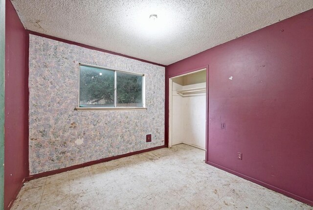 10410 Margra Ln, Austin, TX 78748 - unfurnished bedroom with a textured ceiling, tile patterned floors, and a closet