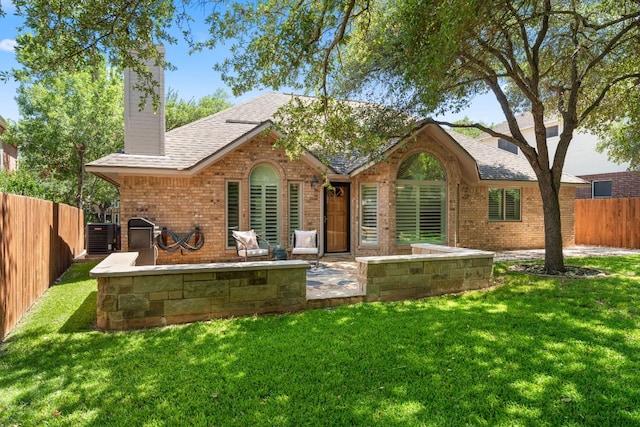 10808 Redmond Rd, Austin, TX 78739 - rear view of property featuring a chimney, a patio, brick siding, and a fenced backyard