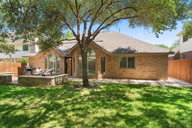 10808 Redmond Rd, Austin, TX 78739 - view of front facade featuring brick siding, a fenced backyard, a patio, and roof with shingles