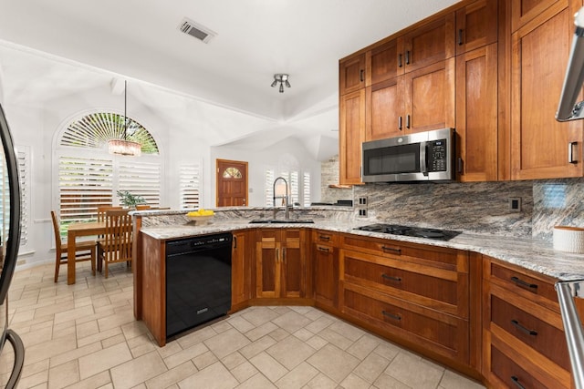 10808 Redmond Rd, Austin, TX 78739 - kitchen featuring black appliances, decorative backsplash, a peninsula, and brown cabinetry
