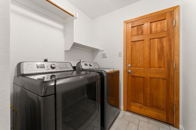 10808 Redmond Rd, Austin, TX 78739 - laundry room featuring washing machine and dryer and light tile patterned flooring
